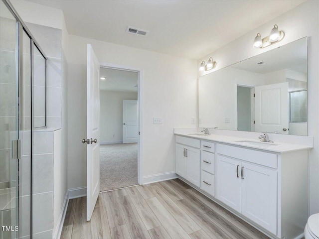 bathroom featuring vanity, a shower with door, and hardwood / wood-style floors