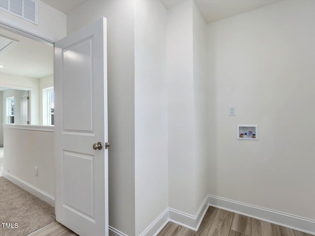 laundry room with hookup for a washing machine and light hardwood / wood-style floors