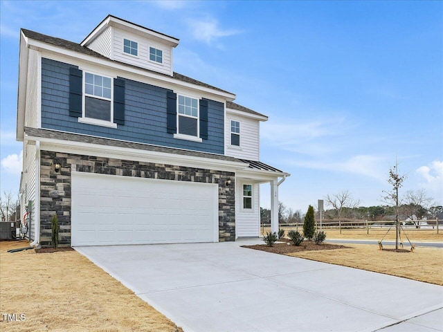 view of front of property featuring a garage and central AC