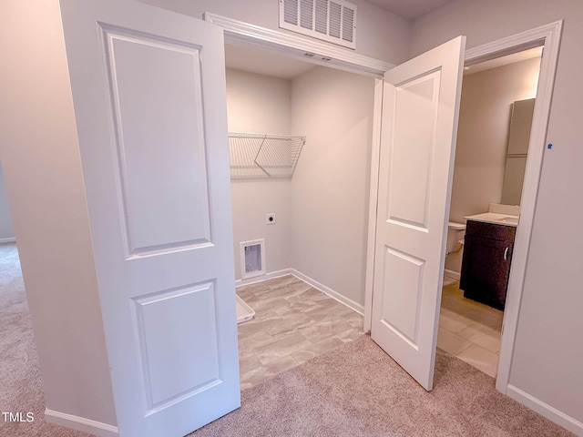 laundry room with hookup for an electric dryer and light colored carpet