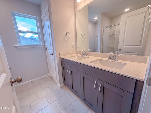 bathroom with tile patterned flooring, vanity, and a shower with shower door