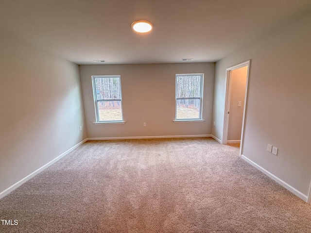 spare room with light colored carpet