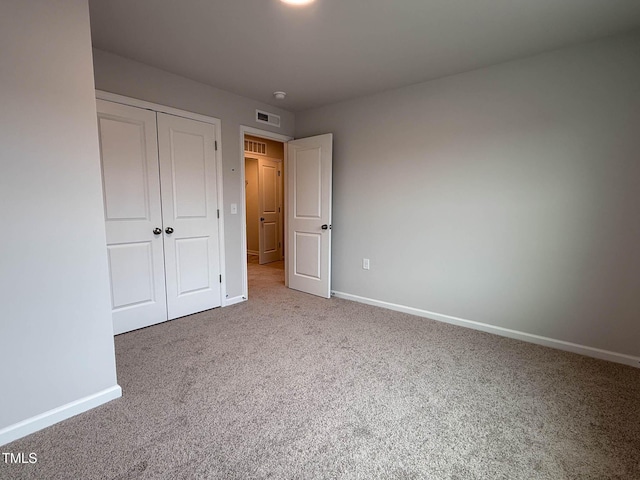 unfurnished bedroom with carpet floors and a closet