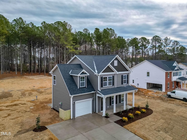 view of front of home featuring a porch and a garage