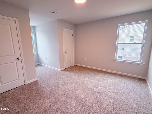 unfurnished room with light colored carpet