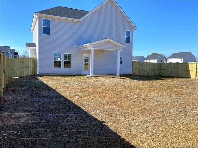 rear view of property with a yard