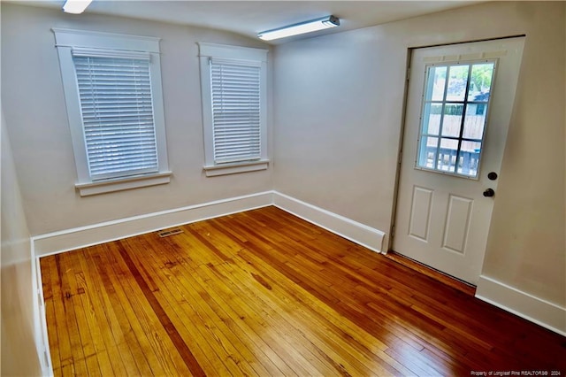 doorway with wood-type flooring