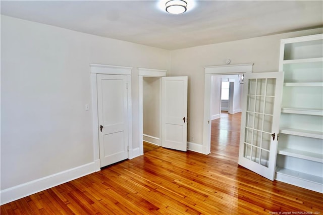 unfurnished room with light wood-type flooring