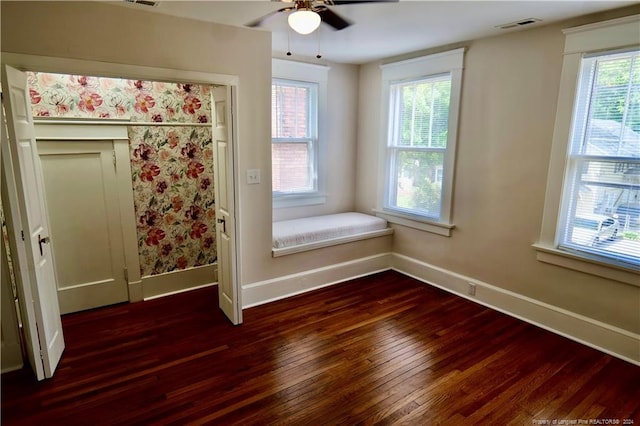 unfurnished bedroom with dark hardwood / wood-style flooring and ceiling fan