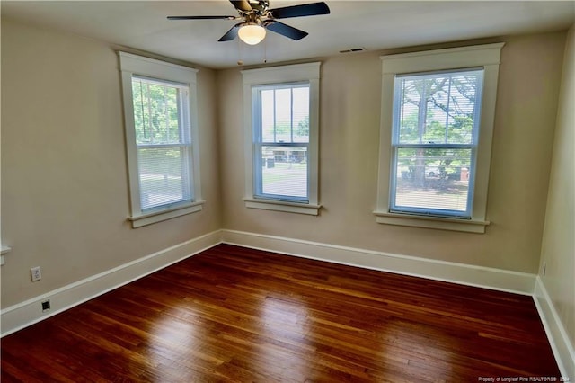 empty room featuring dark hardwood / wood-style floors and ceiling fan