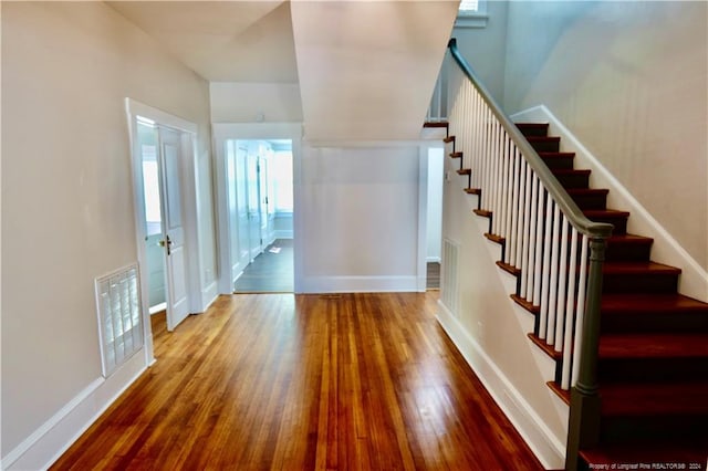 staircase with hardwood / wood-style flooring