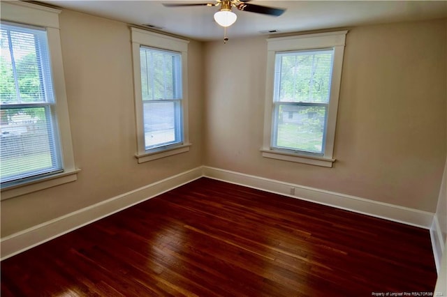 unfurnished room with hardwood / wood-style flooring, ceiling fan, and a healthy amount of sunlight