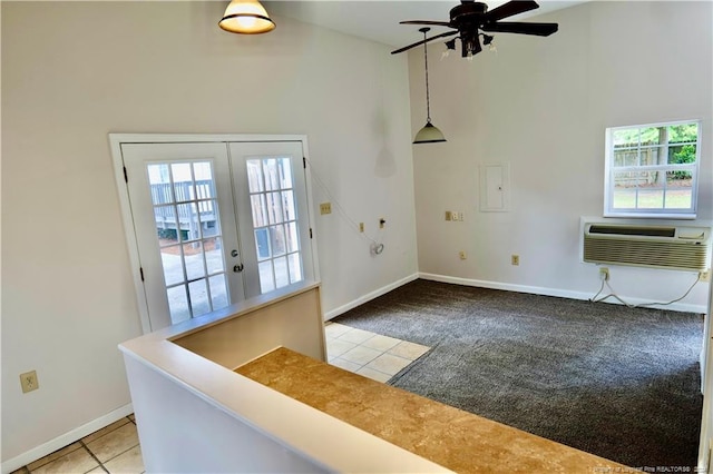 entryway with ceiling fan, light colored carpet, a wall mounted AC, and french doors