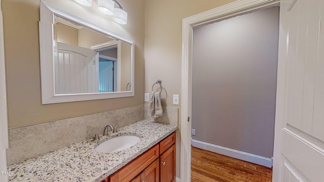 bathroom with hardwood / wood-style floors and vanity