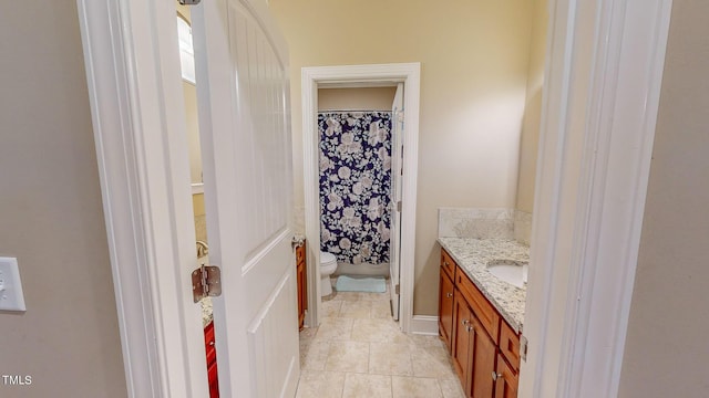 bathroom with tile patterned floors, vanity, toilet, and a shower with shower curtain