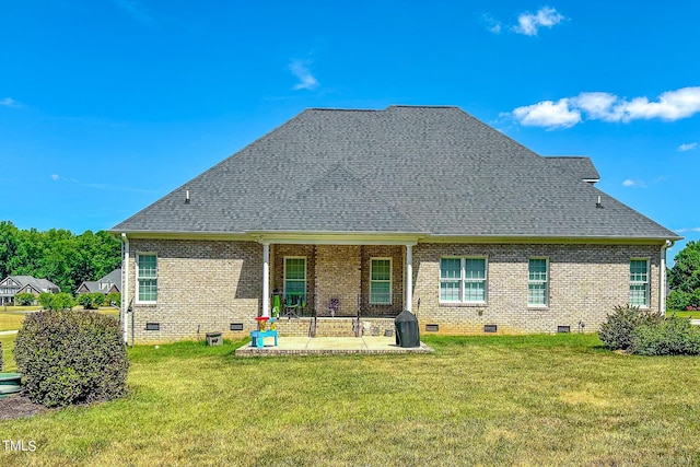 rear view of property with a yard and a patio