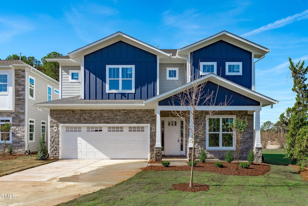 craftsman house featuring a garage and a front yard