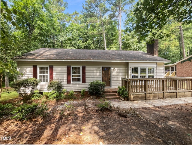 single story home featuring a wooden deck