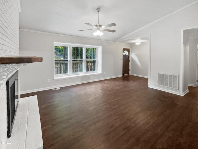 unfurnished living room with dark hardwood / wood-style flooring, a brick fireplace, lofted ceiling, and ceiling fan