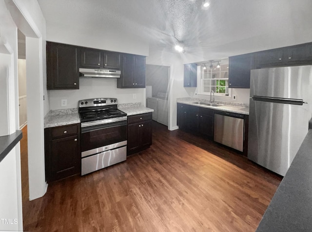 kitchen with sink, dark hardwood / wood-style floors, a textured ceiling, and appliances with stainless steel finishes