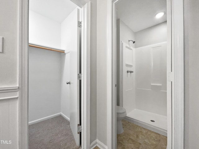 bathroom with toilet and walk in shower