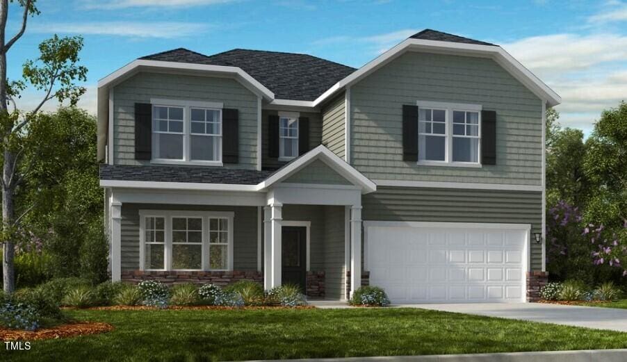 view of front of home with a garage and a front yard