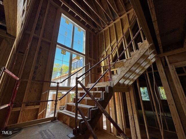 misc room with stairs and a healthy amount of sunlight