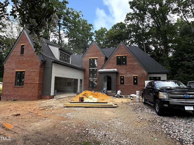 708 Catawba St, Raleigh, NC 27609 - view of front of house featuring brick siding, roof with shingles, and driveway
