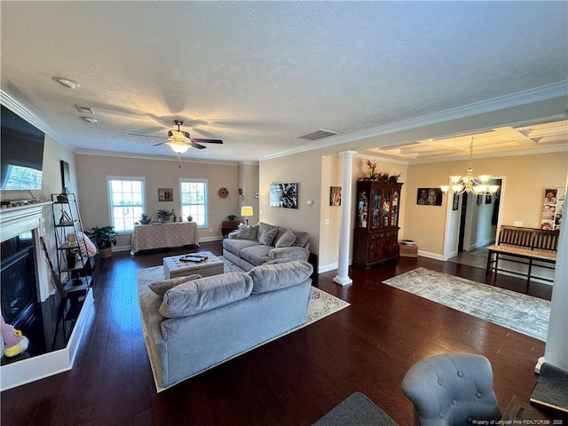 living room featuring crown molding, dark wood-type flooring, a textured ceiling, and ornate columns