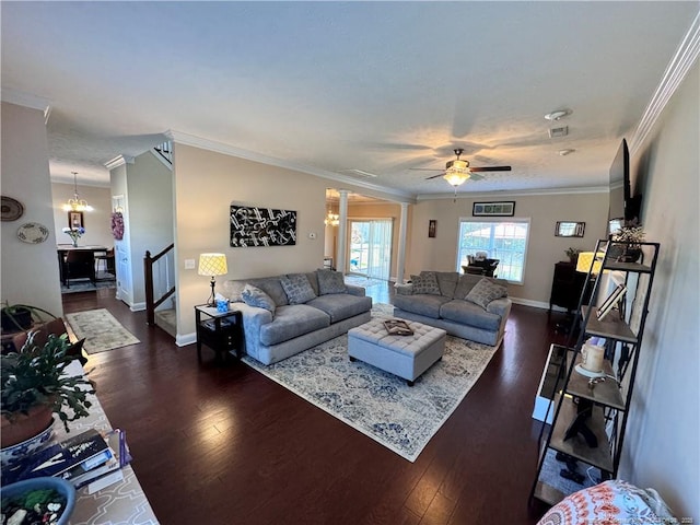 living room featuring ornamental molding, dark hardwood / wood-style floors, and ceiling fan with notable chandelier