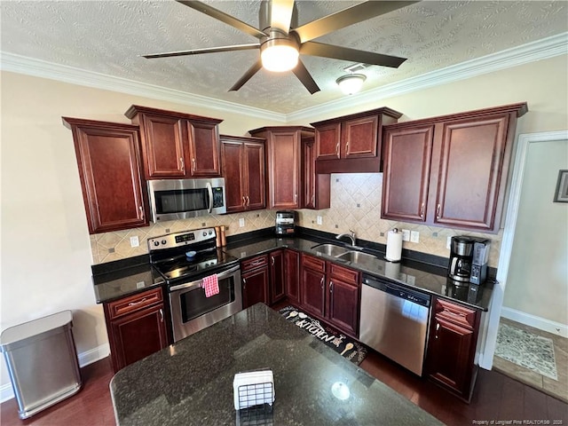 kitchen with tasteful backsplash, ornamental molding, appliances with stainless steel finishes, and a textured ceiling