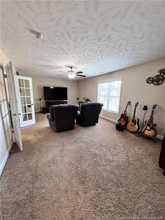 living room with ceiling fan, carpet floors, a textured ceiling, and french doors