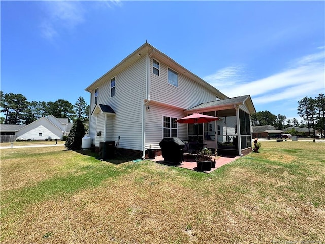 back of property with a sunroom, a yard, a patio area, and central air condition unit