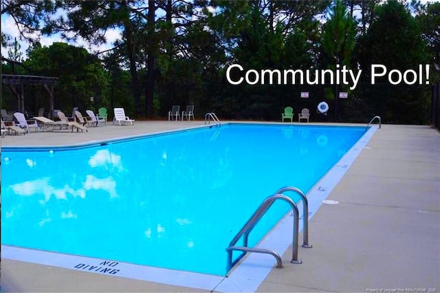 view of swimming pool featuring a patio area