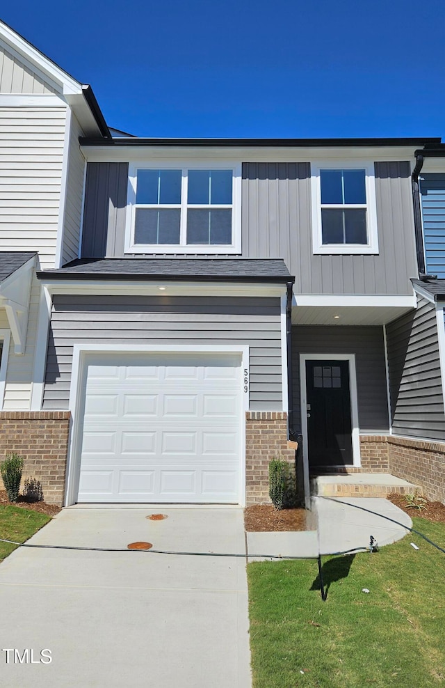 view of front of home with a front yard and a garage