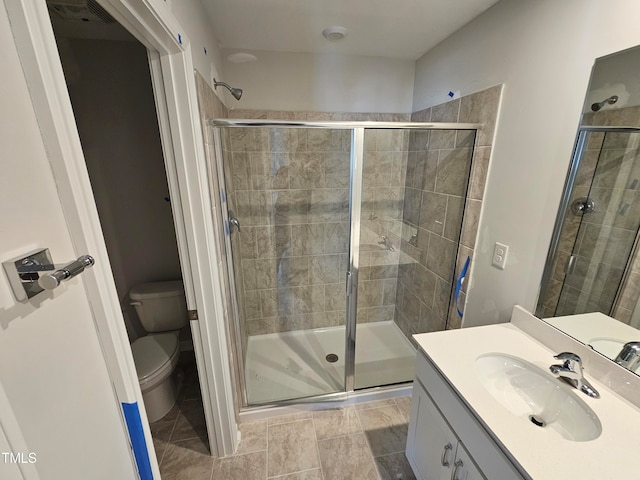 bathroom with vanity, toilet, and an enclosed shower