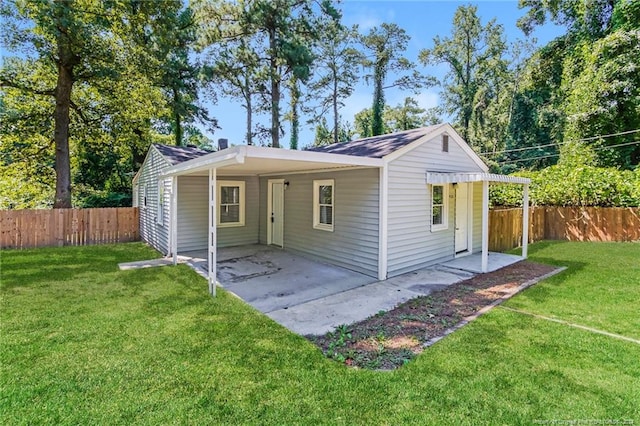 view of front of house featuring a front lawn and a patio area