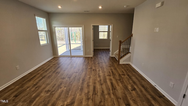 doorway to outside featuring a wealth of natural light and dark hardwood / wood-style flooring