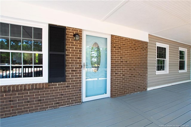 view of exterior entry with a porch