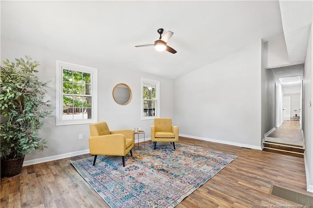 sitting room with dark hardwood / wood-style flooring and ceiling fan