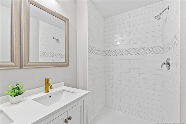 bathroom featuring vanity and tiled shower