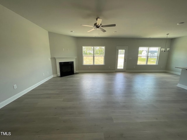 unfurnished living room with ceiling fan and light hardwood / wood-style floors