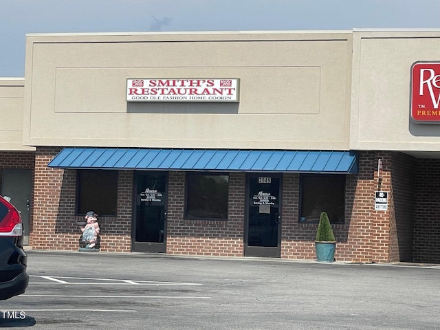 view of building exterior with uncovered parking