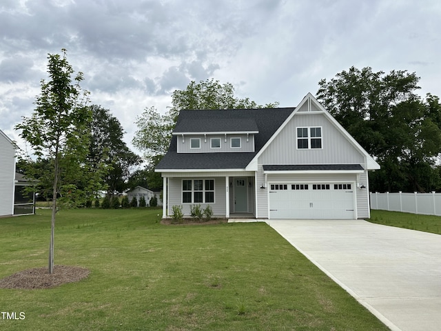 view of front of property featuring a garage and a front lawn