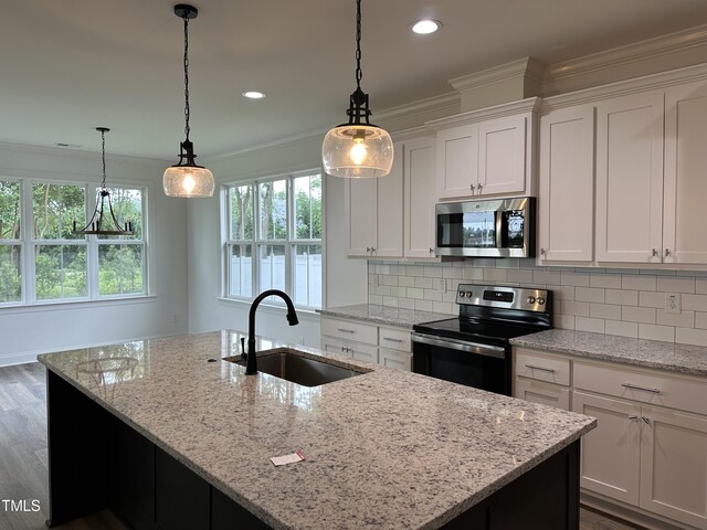 kitchen featuring white cabinetry, an island with sink, appliances with stainless steel finishes, and sink