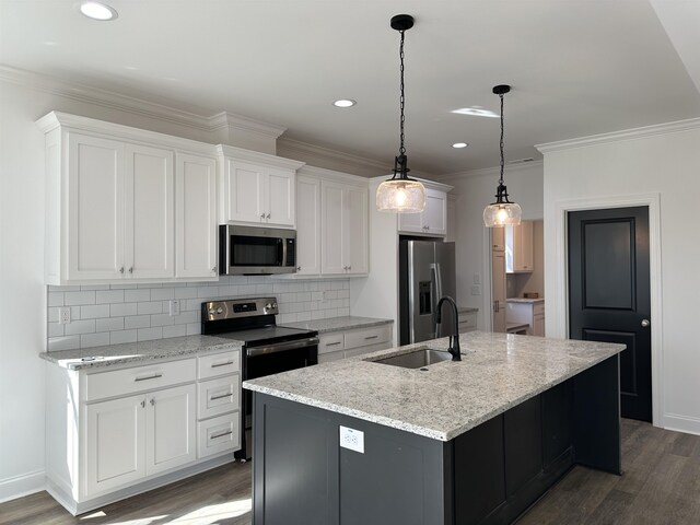 kitchen with dark wood-type flooring, sink, white cabinetry, a center island with sink, and stainless steel appliances