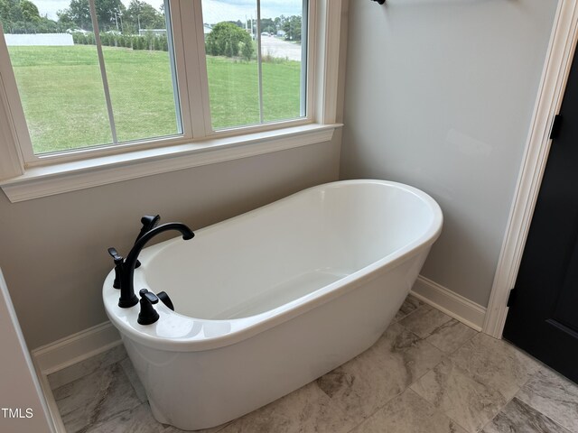 bathroom featuring a tub to relax in