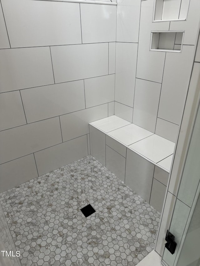 bathroom with tiled shower