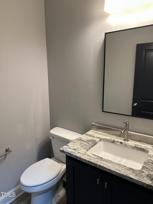 bathroom featuring vanity and toilet