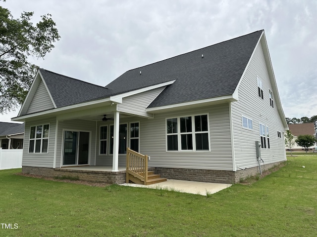 back of house featuring a patio area, ceiling fan, and a lawn